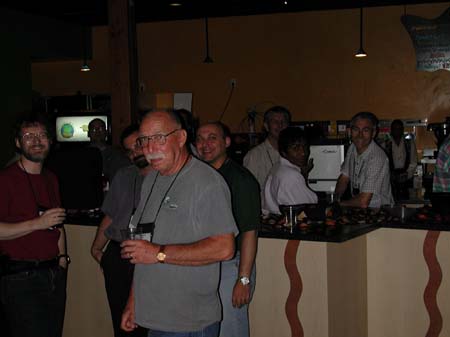 Richard Kilmer standing in front of Michael Ormes,  Mauro Rech, Mark Tate-Smith, Surya Raju, and Simon Price and others