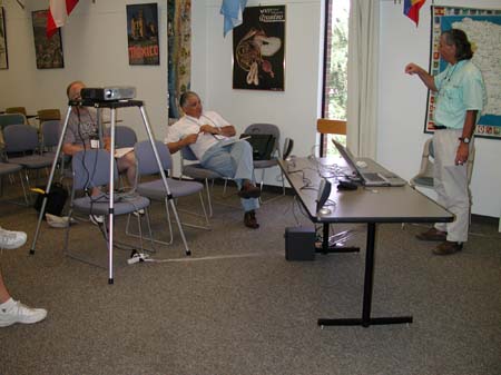 Luis Lloréns and others take in a presentation by Mike Cline