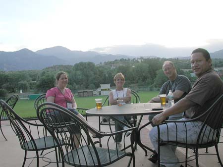Kate Hacket, Tammy Blakeslee, John Chapman, and Jose Rodriguez relaxing on the patio during Sunday's social